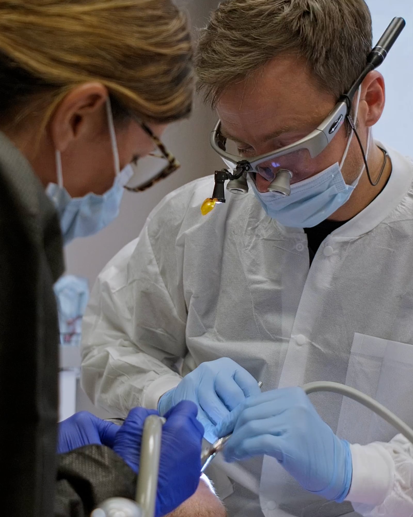 Dr. Nathan Powers and a dental assistant caring for a patient at Powers Family Dental Care